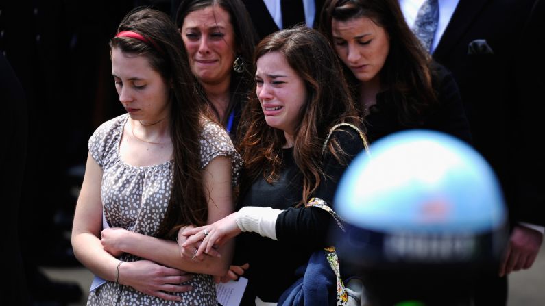 Mourners walk out of St. Joseph Catholic Church after Campbell's funeral service.