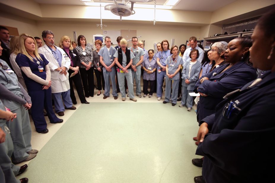 Staff members of the Beth Israel Deaconess Medical Center gather inside a trauma room to observe a moment of silence on April 22, 2013.