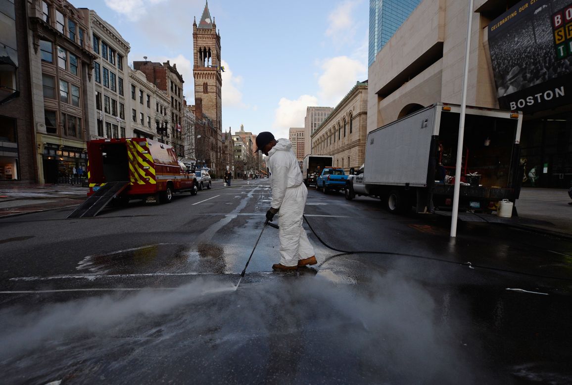 A cleaner power washes Boylston Street near the blast site after the FBI handed the area back to the city of Boston on Monday, April 22, following the week-long investigation.