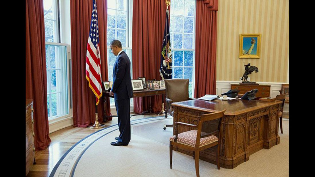 President Barack Obama observes a moment of silence in the White House Oval Office on April 22, 2013.