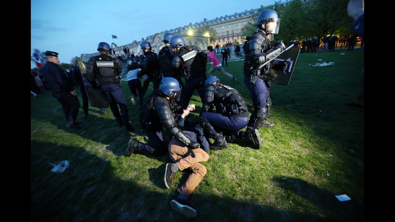 Police officers hold down a demonstrator at the "La Manif Pour Tous" demonstration on Sunday.