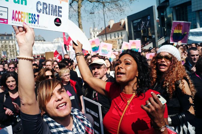People yell in support of the new law Sunday in Bastille Square.