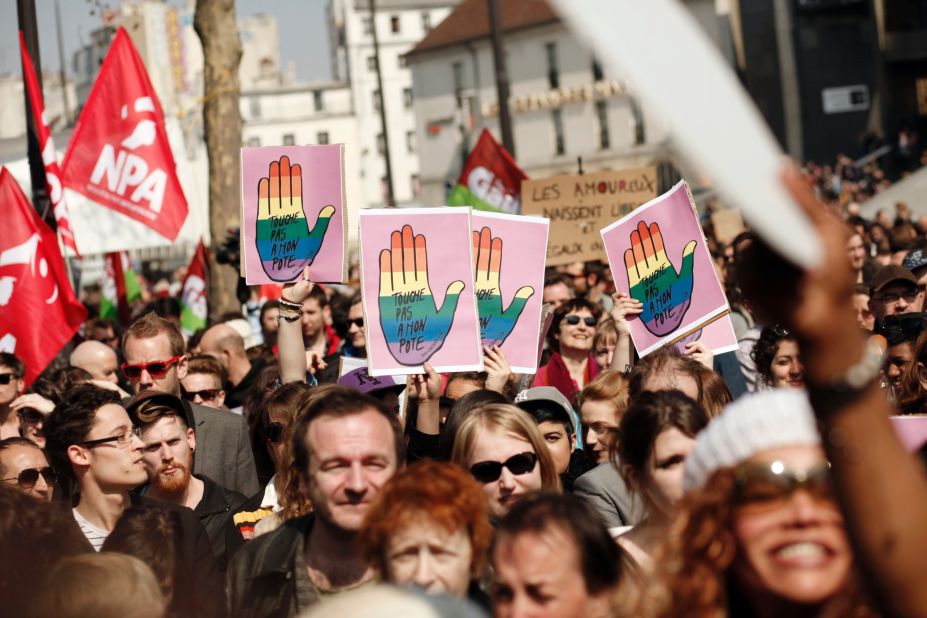 Gay marriage supporters raise signs in Bastille Square on Sunday.