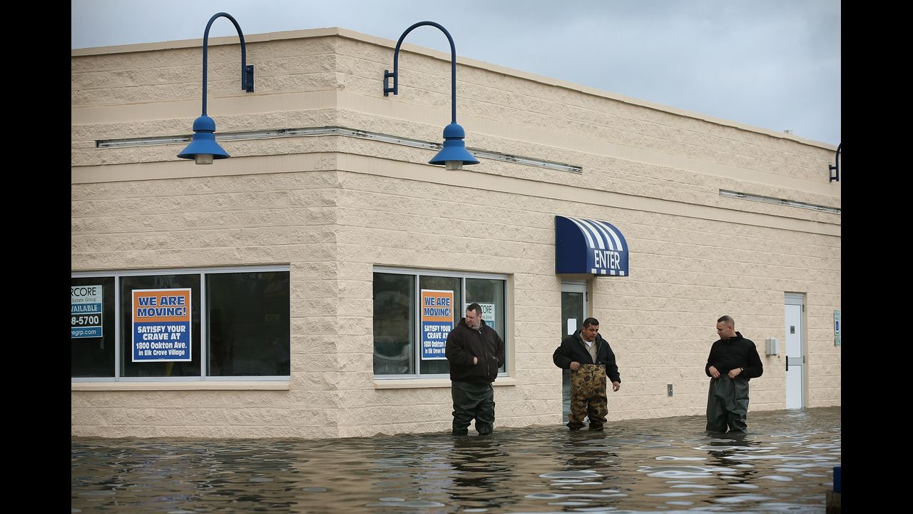 Workers inspect flood damage to a building in Des Plaines on April 19. At least six rivers in northern Illinois have surged to record levels recently after five inches of rain pummeled the area.