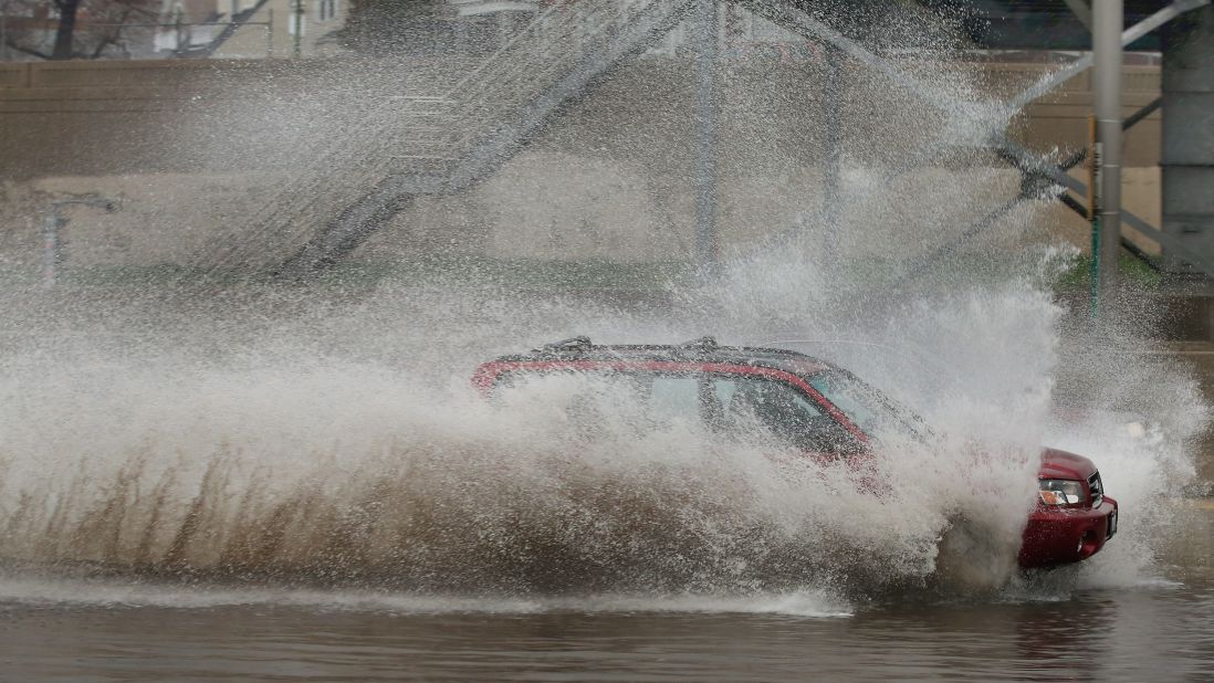 A motorist barrels through a flooded section of the Kennedy Expressway on Thursday, April 18, in Chicago.