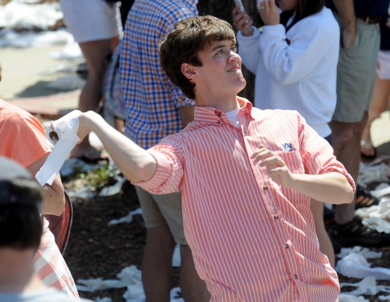 An Auburn fan prepares to fling a roll on Saturday.