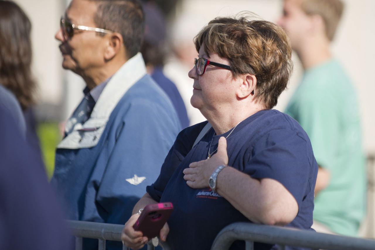 A woman is overcome with emotion while watching the trees get cut down on Tuesday.