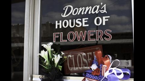Donna's House of Flowers is closed, and a note on the door explains the tragic reason: Her husband and brother-in-law, both volunteer firefighters, died in the explosion.