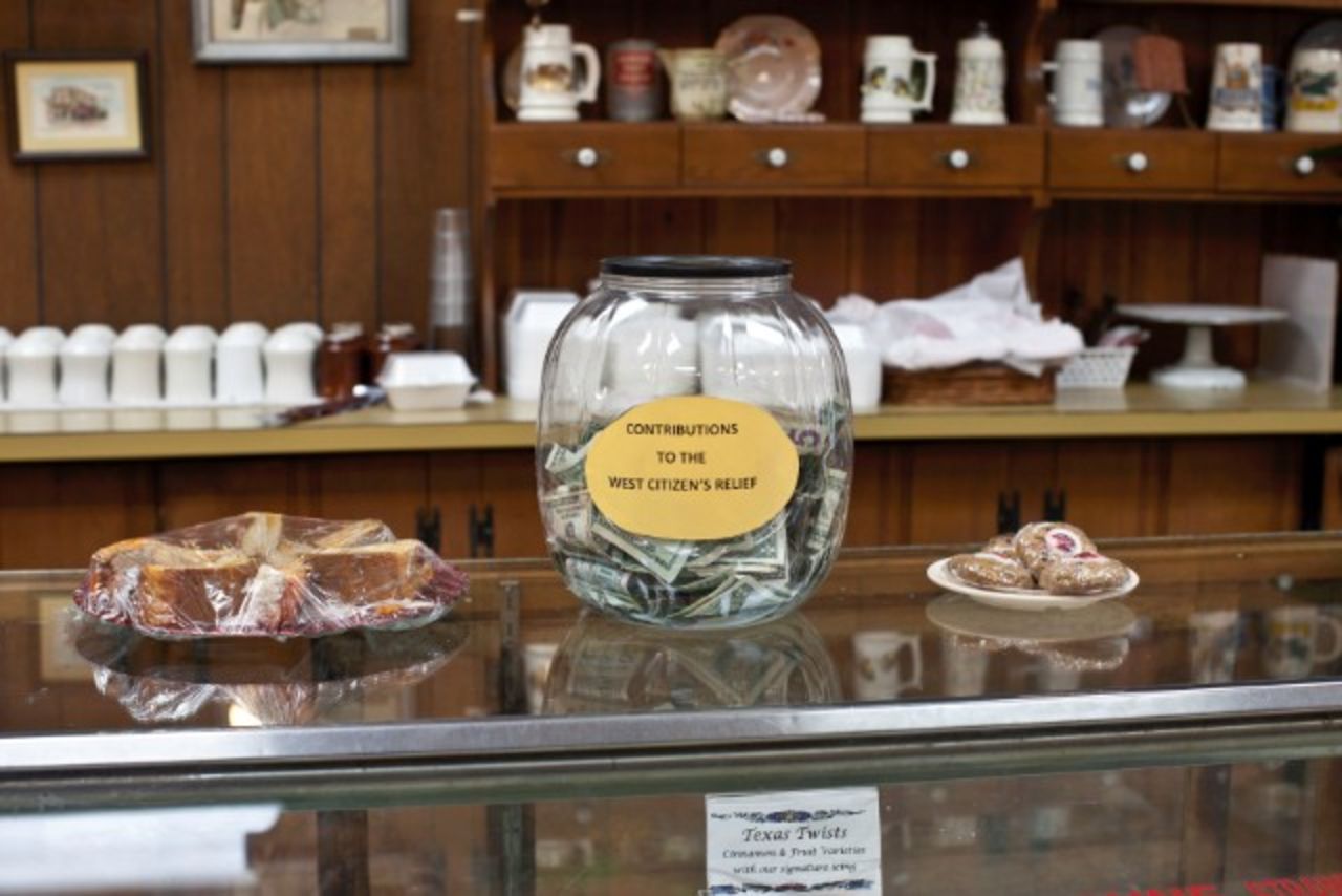 A donation jar fills at The Village Bakery in West, where people look out for their own.