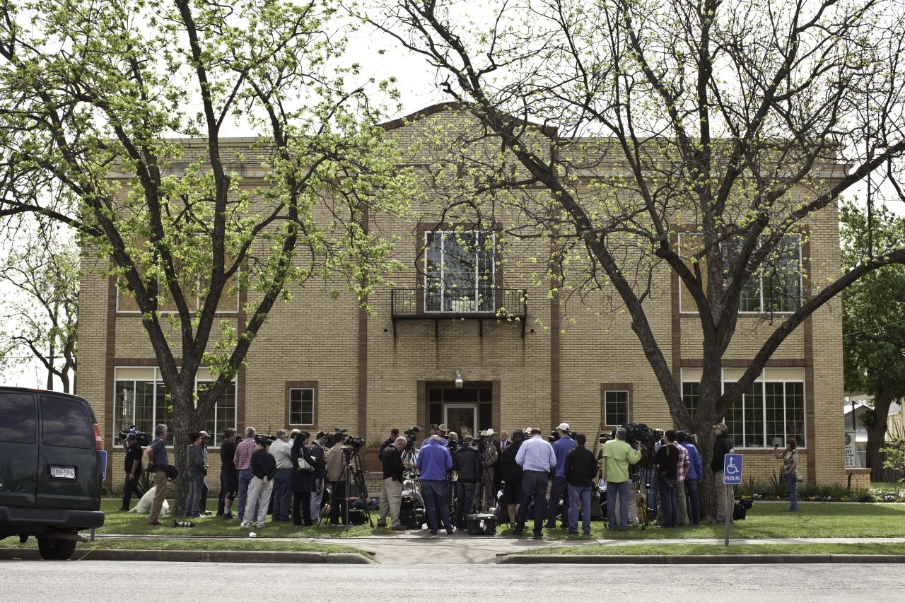 Folks in West don't know what to make of all the media, like this scrum at City Hall.