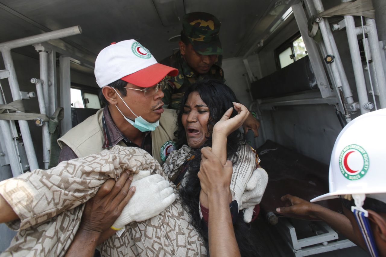 A rescue worker carries a worker to an ambulance on April 24.