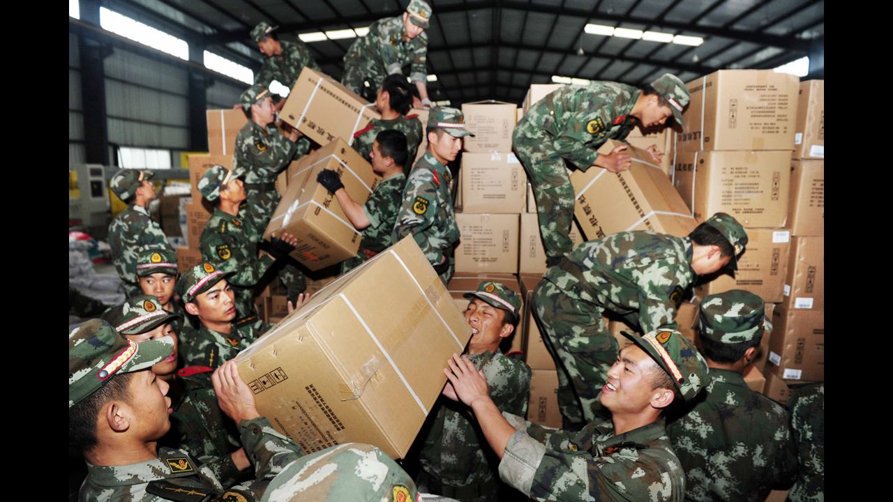 Rescue workers unload medicine in Ya'an on Tuesday.