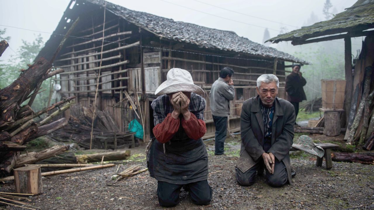 A man and woman react to the damage in Ya'an on Tuesday.