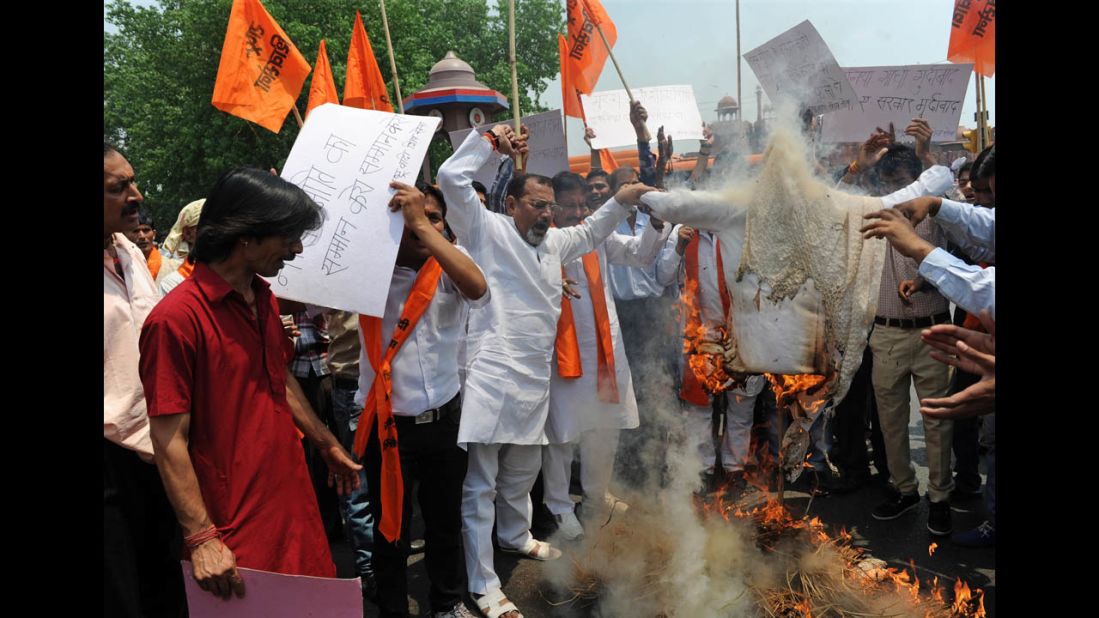 Activists burn an effigy of Delhi Chief Minister Sheila Dikshit during a protest in front the landmark of Red Fort in New Delhi on April 23.