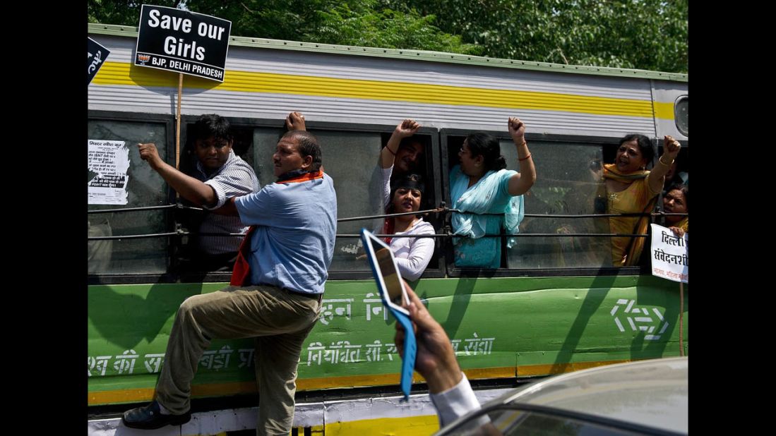 Activists shout slogans after being detained following a protest in New Delhi on April 22.