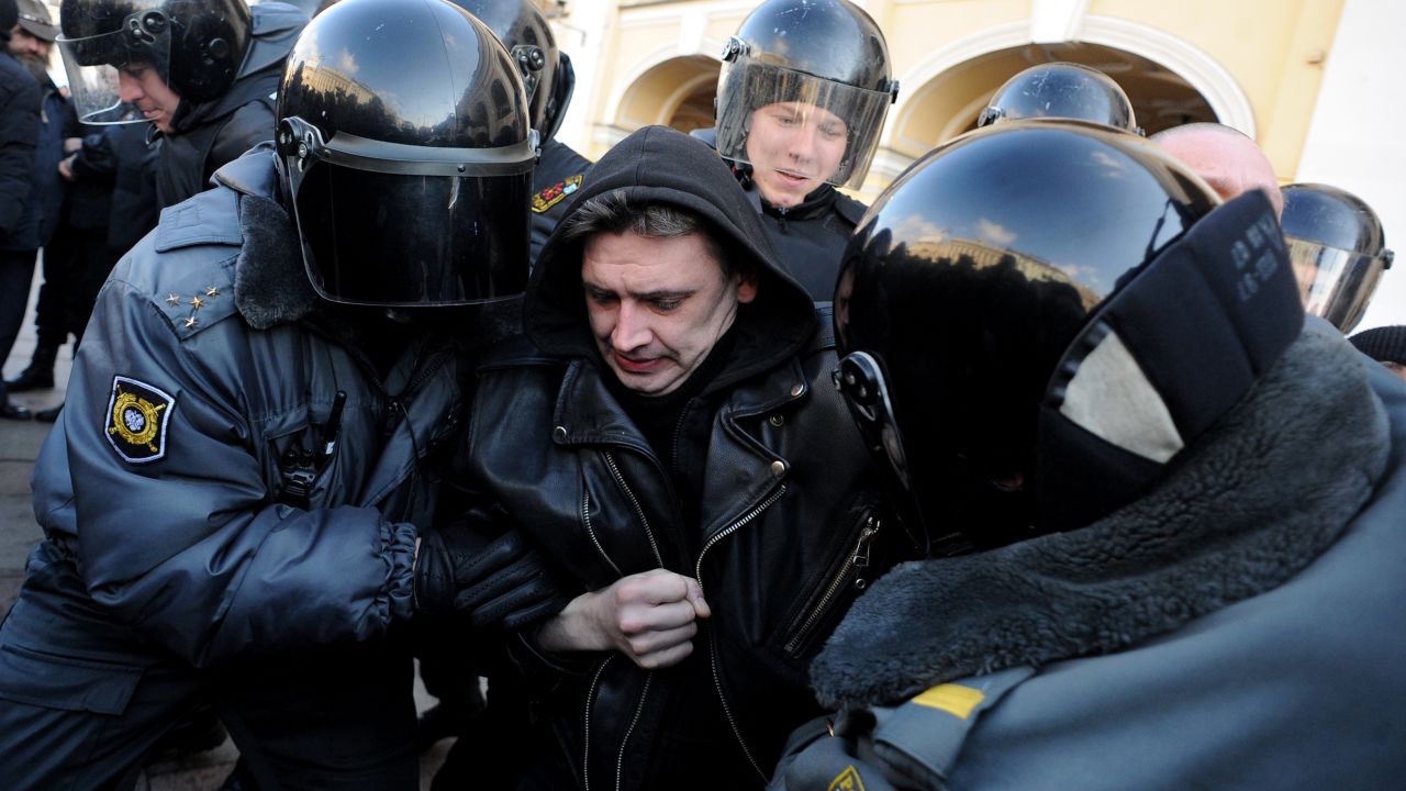 Riot police officers detain an activist in central St. Petersburg on March 31, 2013, during an unauthorized protest rally.