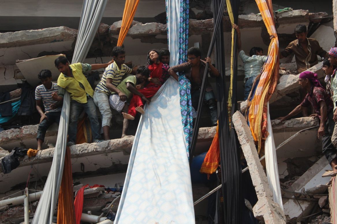 Rescuers help an injured garment worker to escape from the Rana Plaza building on the outskirts of Dhaka on April 24. 
