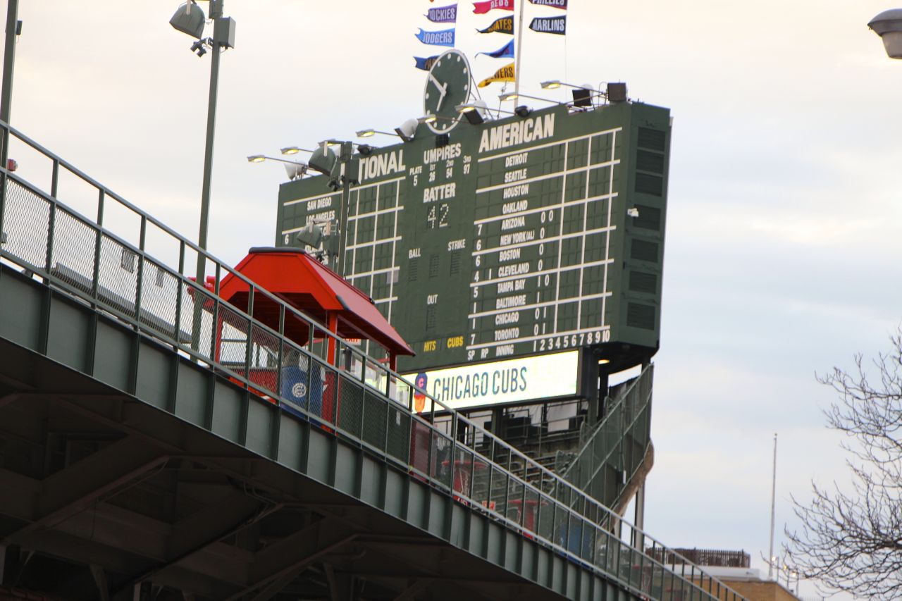 Wrigley Field's manually-operated scoreboard is a beloved, historic icon. It may soon get company from a proposed 6,000 square foot video screen to its left.