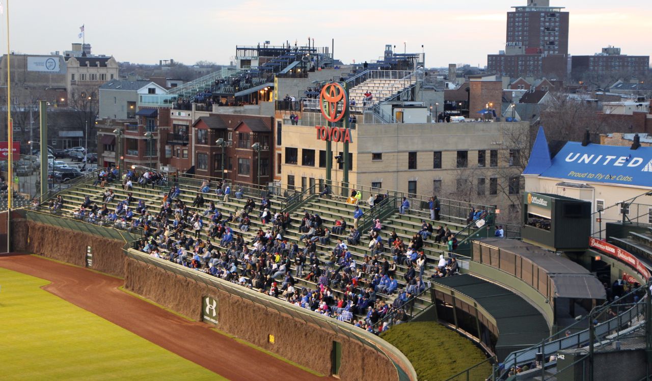 Rooftop bleachers, such as the ones seen here behind Wrigley Field's center field, might be in danger of losing their views under a new stadium renovation plan. <br />