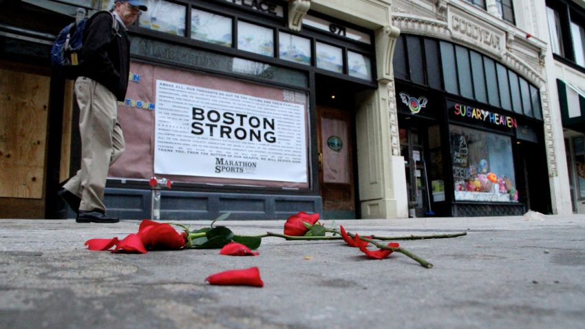 Flowers lie on the sidewalk adjacent to Boston's Boylston Street, which reopened a week after the twin terror bombings. 