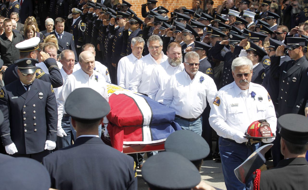 Pallbearers carry the casket of fallen firefighter Capt. Kenneth "Luckey" Harris Jr. after his funeral at St. Mary's Catholic Church of the Assumption in West, Texas, on April 24.