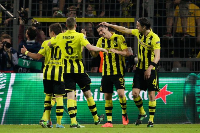 Dortmund's players celebrate with Lewandowski after he becomes the first player to score four times in a semifinal of the competition since Ferenc Puskas in 1960.