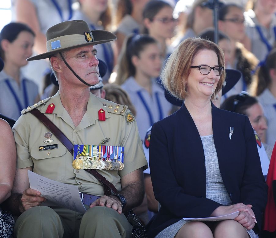 Australian PM Julia Gillard sits with Brigadier Shane Caughey during a commemorative service on Thursday in Townsville, Australia. 