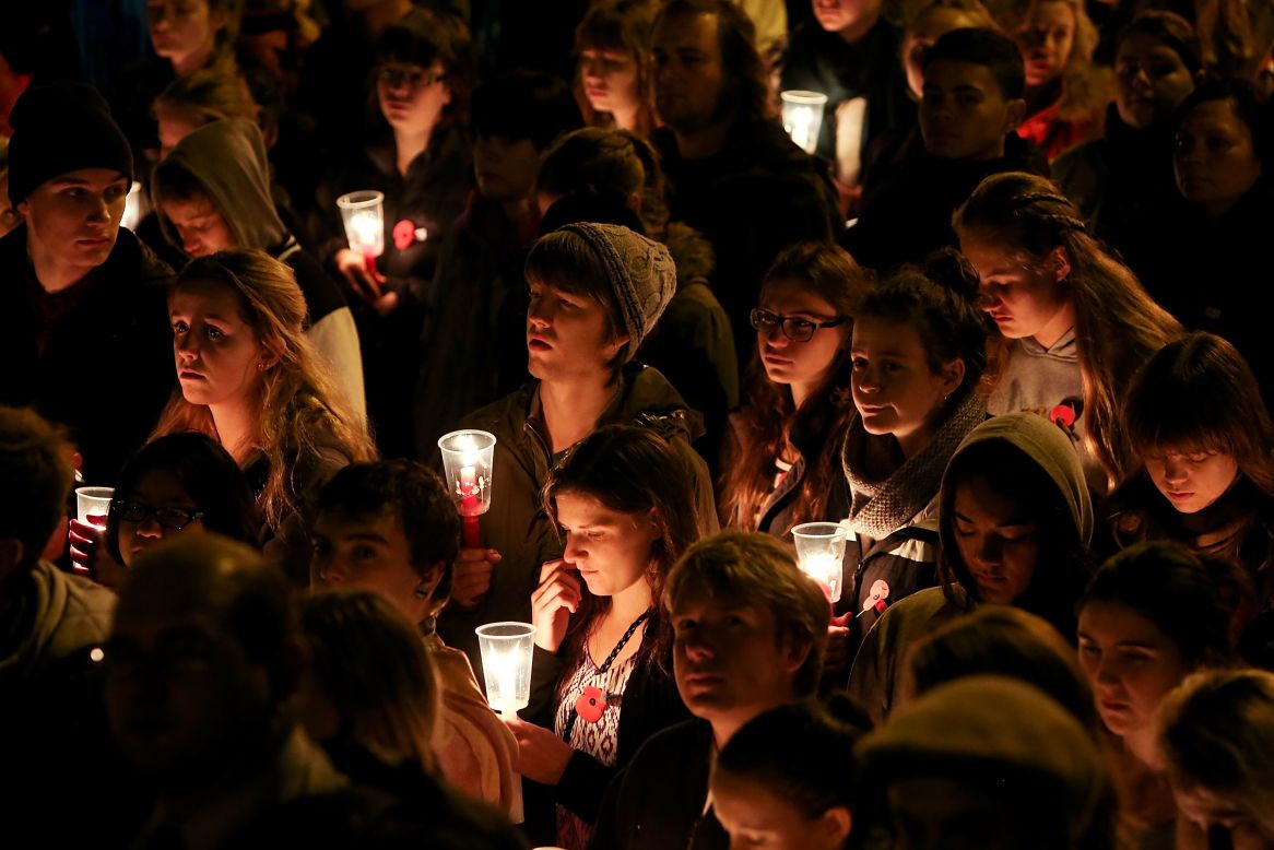 Members of the public hold candles during the dawn service at the Wellington Cenotaph on Thursday in Wellington, New Zealand. 