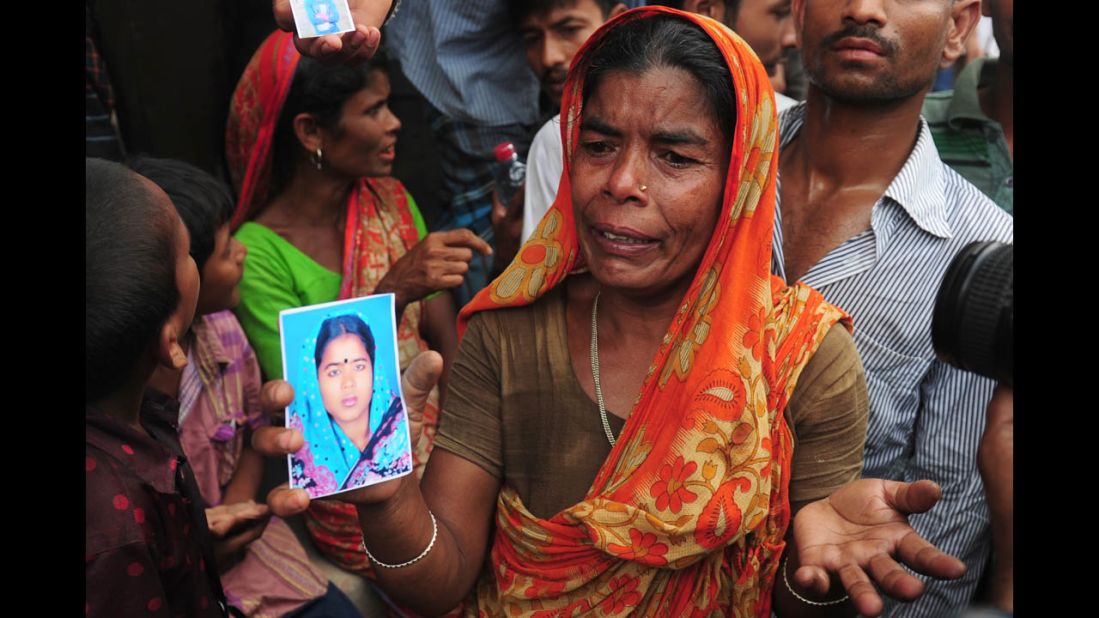 A Bangladeshi woman shows a picture of her missing daughter-in-law she believes is trapped in the collapsed building on April 25.