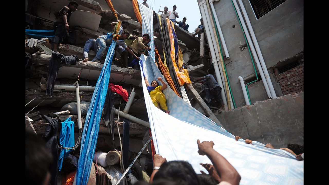 Bangladeshi garment workers help evacuate a survivor by using a roll of fabric on April 24.