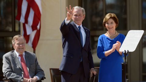 George W. Bush gestures a "W" to the crowd after speaking.