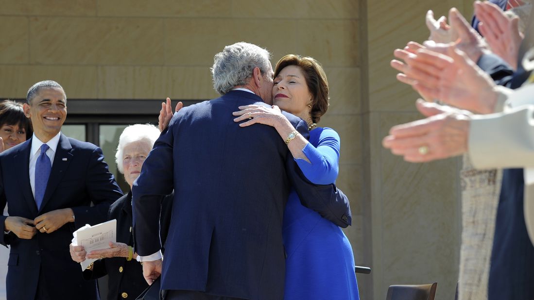 George W. Bush hugs his wife Laura after speaking.
