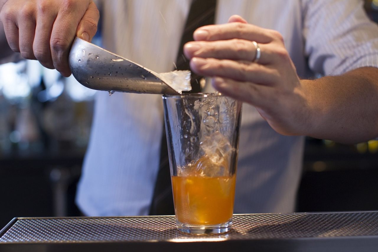 In a mixing glass, add vodka, lime juice, honey syrup, vermouth and bitters. Add ice, and...