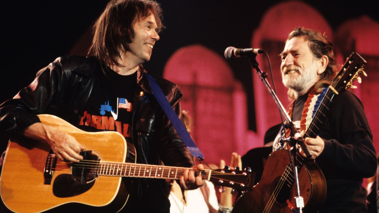Neil Young and Nelson perform together at Farm Aid in Indianapolis in 1990.