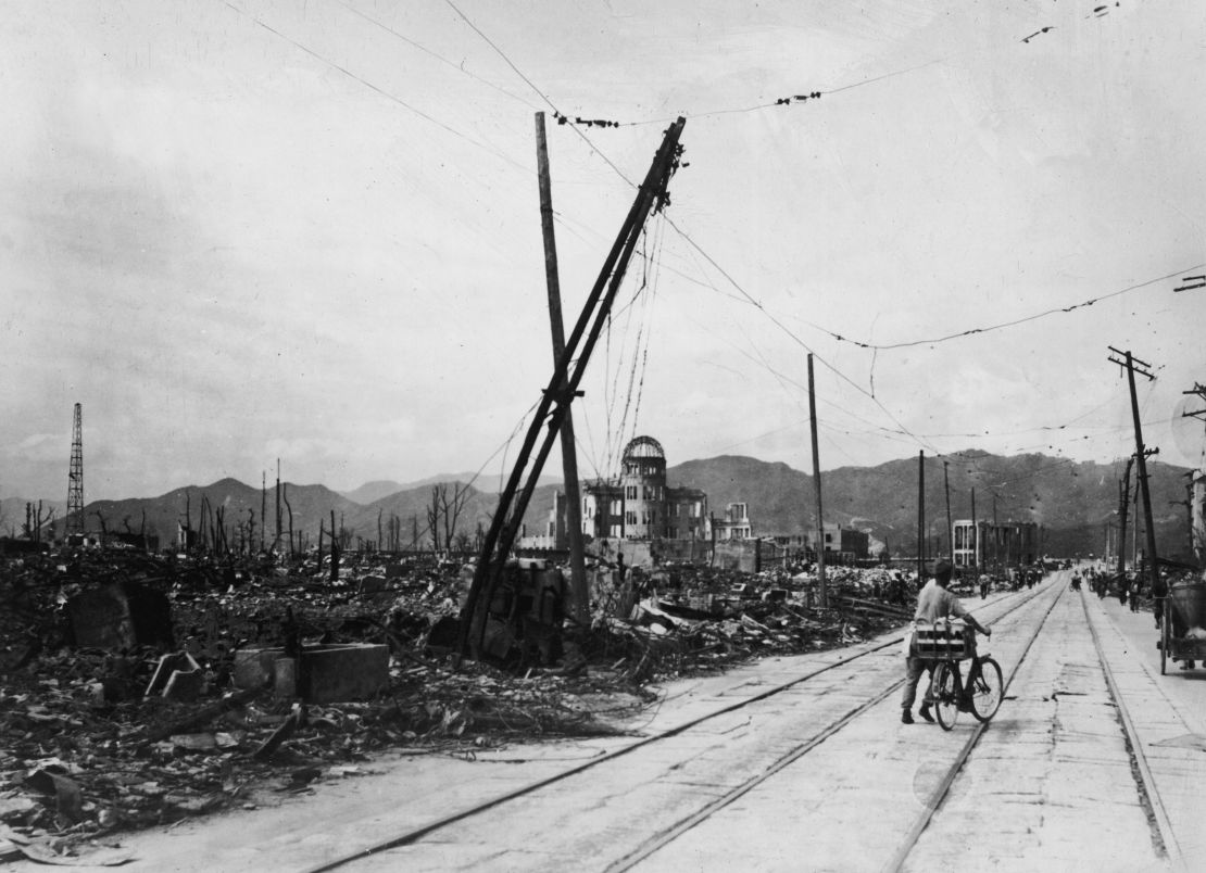 A man wheels his bicycle thorough Hiroshima in August 1945, days after the city was leveled by an atomic bomb blast.