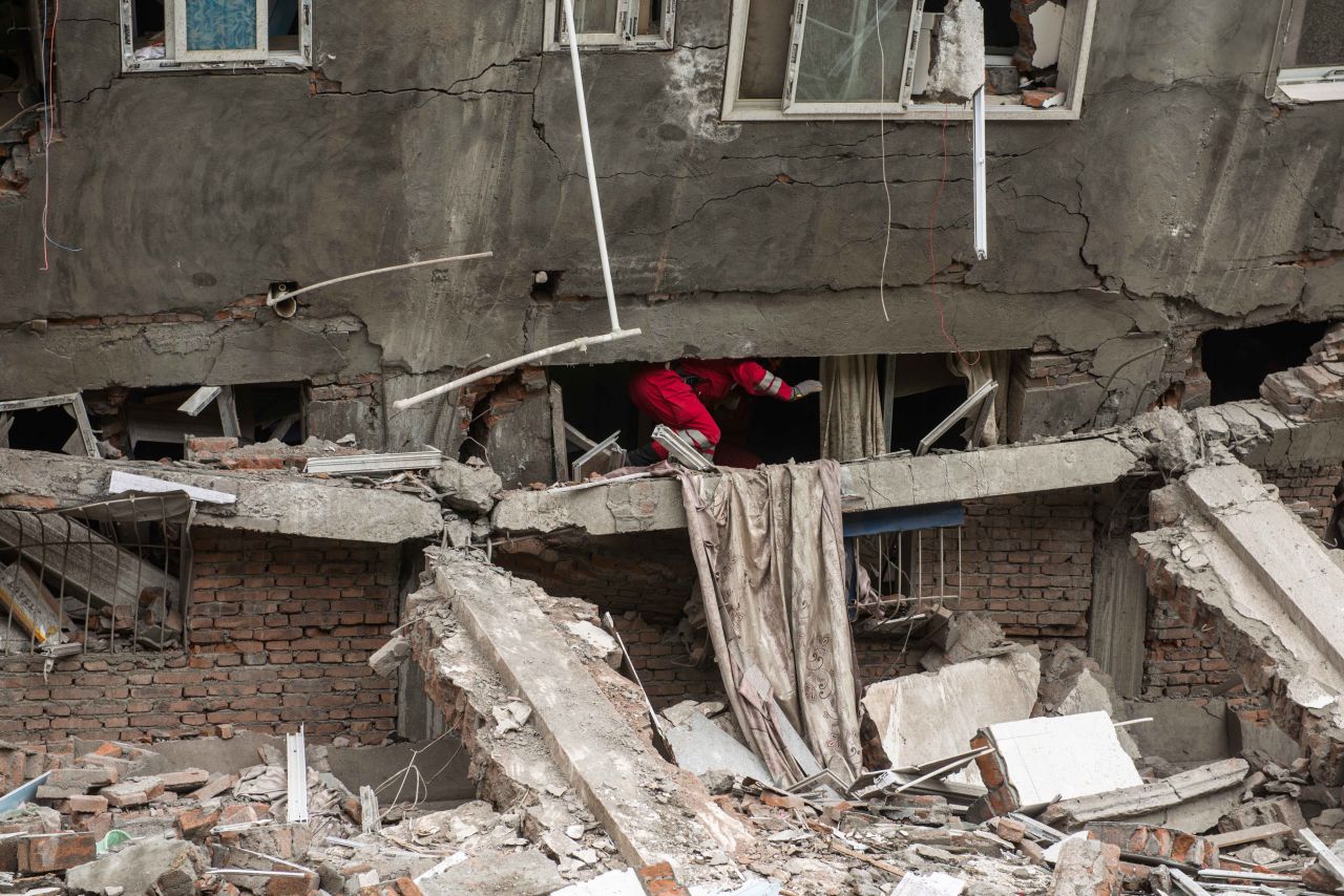 Rescuers check a collapsed building in Lingguan township in Ya'an.
