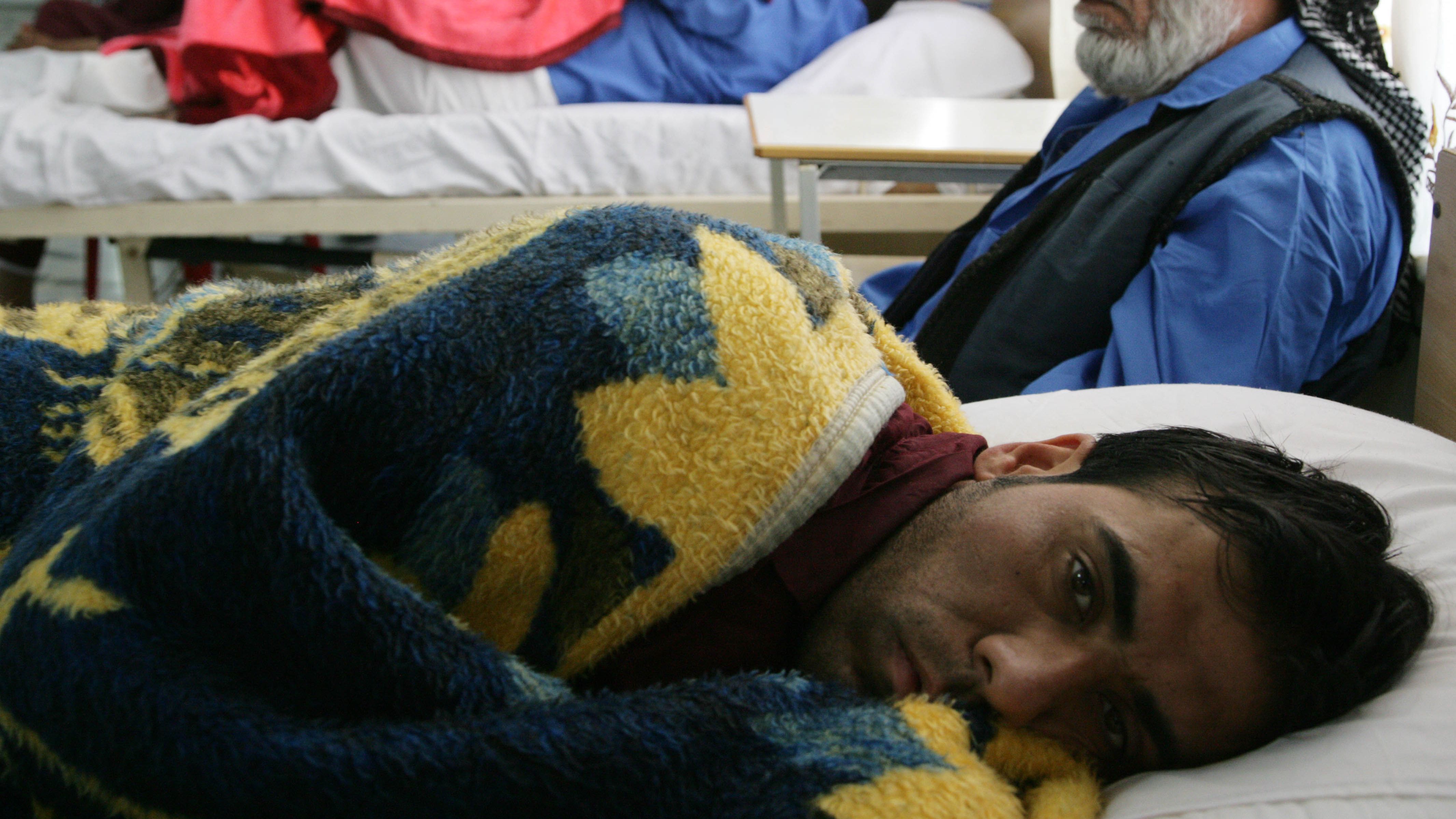 Wounded Iraqi men rest at a hospital in the northern Iraqi city of Arbil on April 25, 2013.