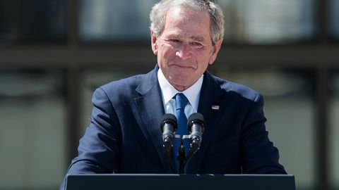 Former President George W. Bush holds back tears as he finishes his speech.