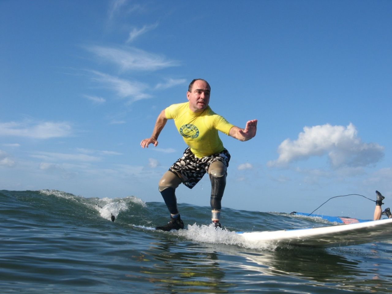 Cain enjoys and competes in a variety of adaptive sports, including surfing.