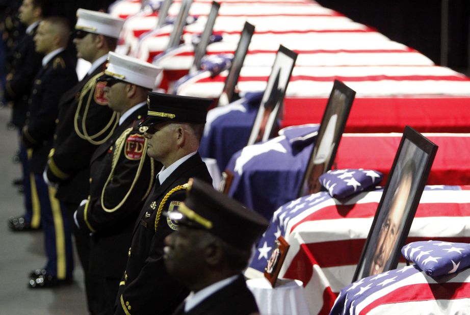 A firefighters honor guard stands before the coffins of fallen comrades on April 25.