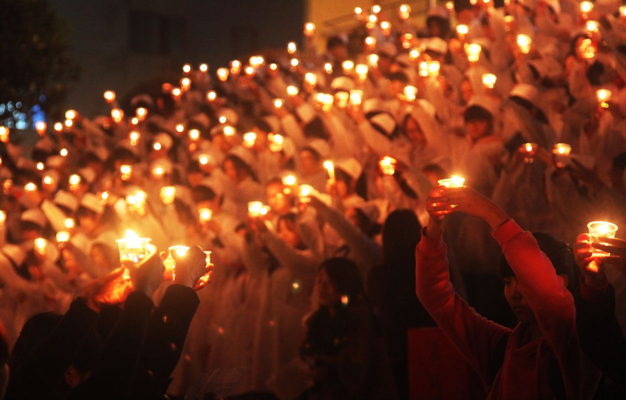 Students of the University of South China light candles to pray for quake victims on April 24 in Hengnan, China.