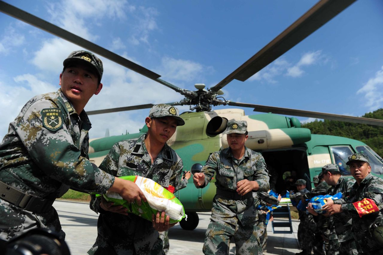 Rescuers load relief supplies onto a helicopter in Ya'an on April 24.