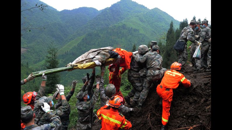 Rescuers carry a victim's body in the Taiping township of Ya'an on April 25.