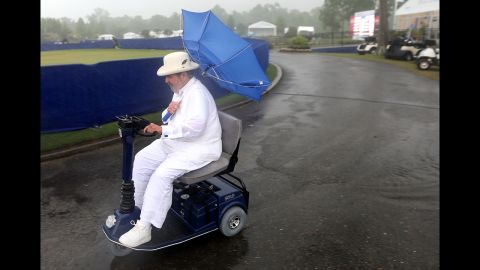 Chef Paul Prudhomme heads to the Zurich Classic Pro-Am clubhouse at TPC Louisiana as officials order the evacuation of all temporary structures after a tornado warning in New Orleans on Wednesday, April 24.
