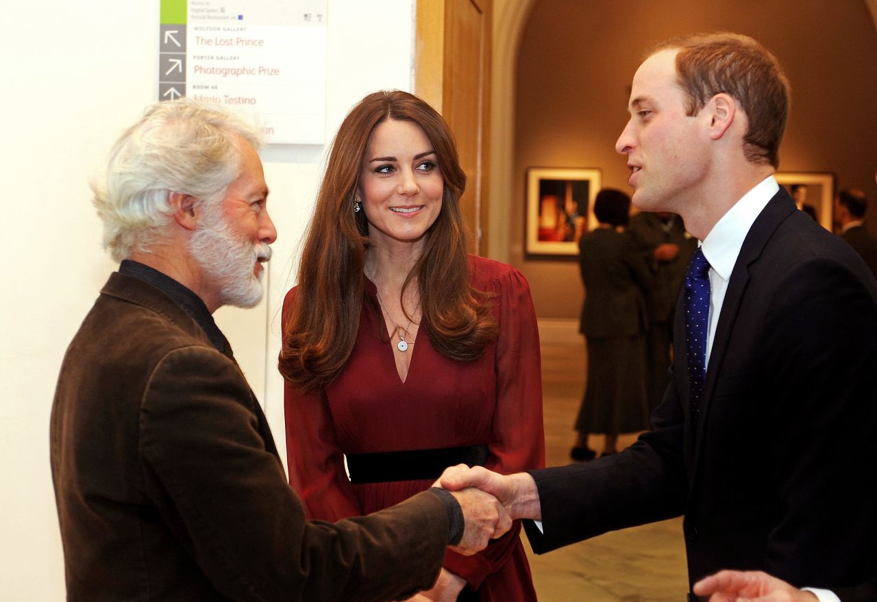 Prince William shakes hands with artist Paul Emsley as Catherine looks on after viewing his <a href="http://www.cnn.com/2013/01/11/world/europe/duchess-of-cambridge-first-portrait">new portrait of the Duchess</a> during a private viewing at the National Portrait Gallery on January 11.
