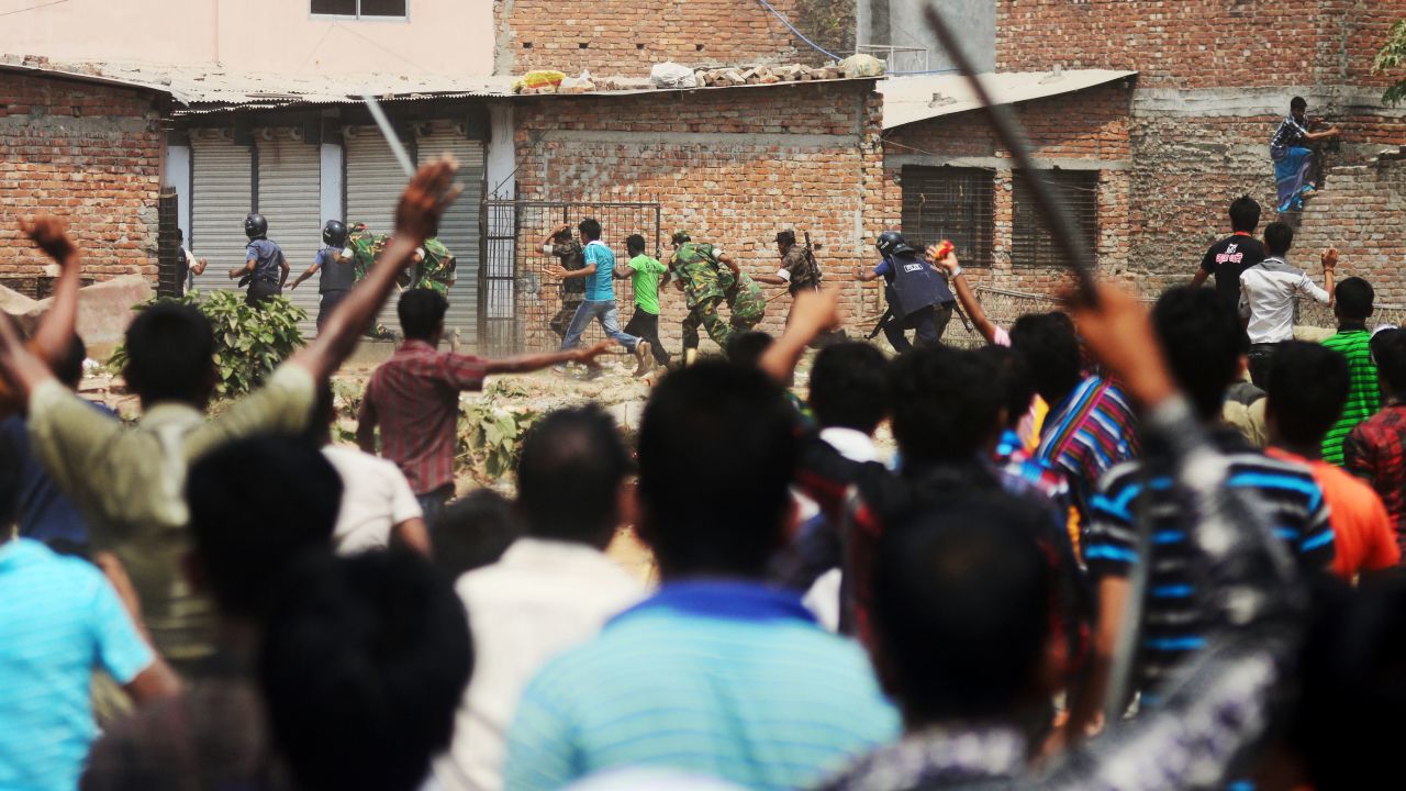 Bangladeshi army personnel and police from villagers on Friday, April 26, after protests broke out at the site of a building collapse 48 hours earlier in Savar, outside Dhaka. 