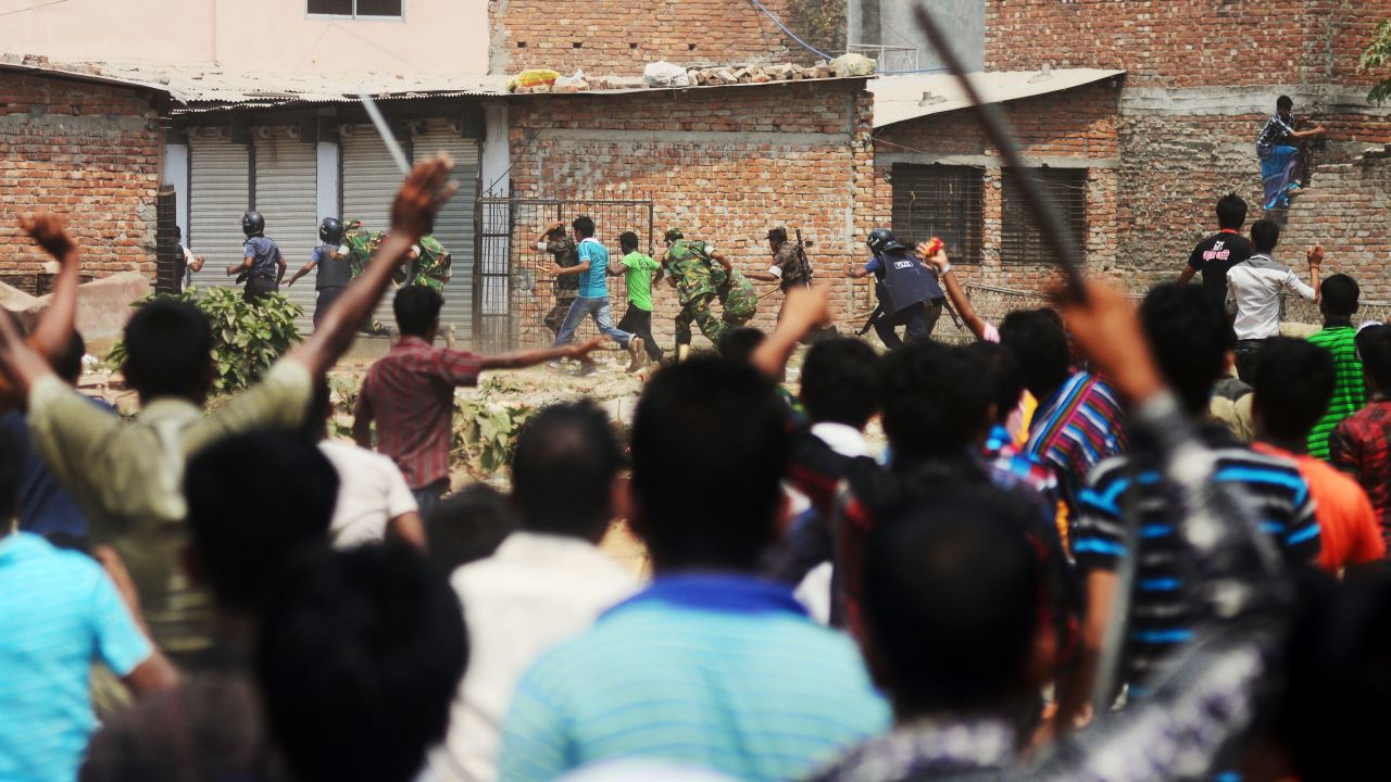 Bangladeshi army personnel and police from villagers on Friday, April 26, after protests broke out at the site of a building collapse 48 hours earlier in Savar, outside Dhaka.