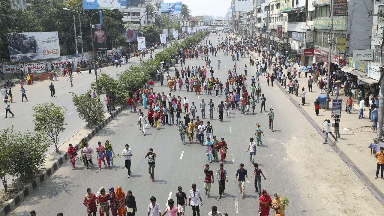 Garment workers block a street as they march to demand the arrest of the owner of the Rana Plaza building.