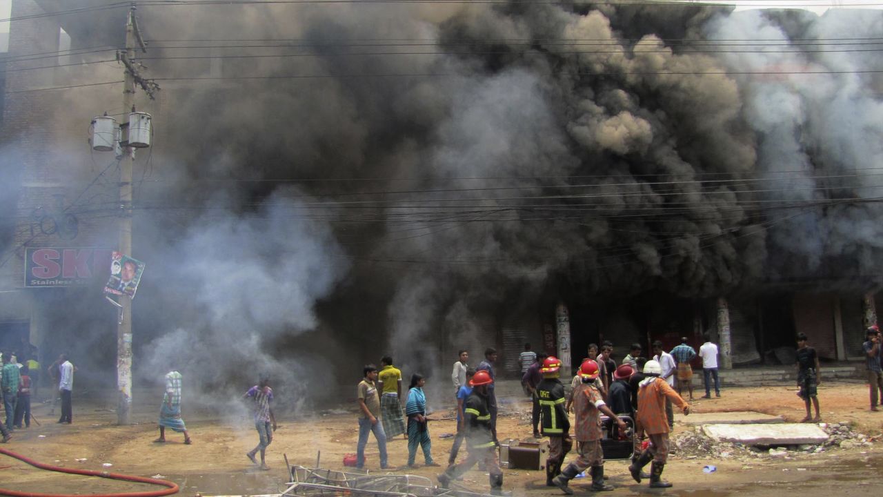 Firefighters work after protesters set fire to a spinning mill in Gazipur.