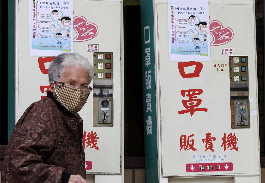 A woman wearing a medical mask walks past vending machines that sell masks outside National Taiwan University Hospital in Taipei on April 26. A 53-year-old Taiwanese businessman has contracted the H7N9 strain of bird flu while traveling in China, Taiwan's Health Department said on April 24. It's the first reported case outside of mainland China. The man was hospitalized after becoming ill three days after returning from Suzhou on April 9.